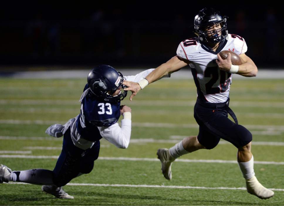 Steve Griffin / The Salt Lake Tribune


Alta's Joshua Davis pushes away Corner Canyon defender Mason North as he sweeps around the end  during Region 7 football game in Draper Wednesday October 19, 2016.