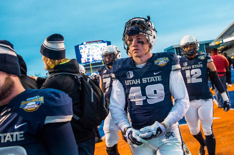 Chris Detrick  |  The Salt Lake Tribune
Utah State Aggies linebacker Derek Larsen (49) walks off of the field after the Famous Idaho Potato Bowl at Albertsons Stadium in Boise, Idaho Tuesday December 22, 2015.  Akron Zips defeated Utah State Aggies 23-21.