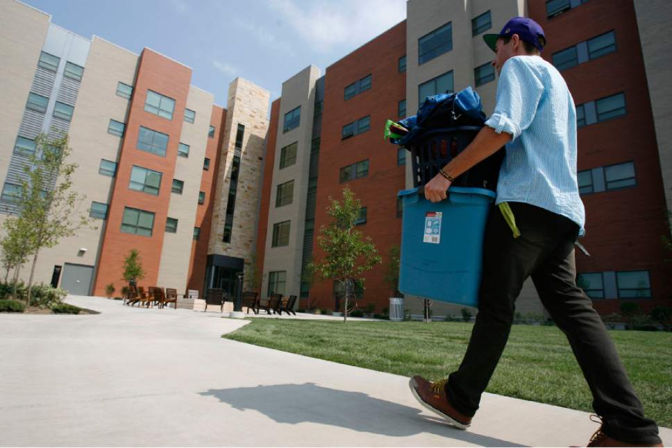 Francisco Kjolseth  |  The Salt Lake Tribune
Dillon Lawler, a sophomore at the University of Utah moves his belongings into the new Donna Garff Marriott Residential Scholars Hall dedicated specifically for Honors students. The new hall, housing 309 students and resident advisors in apartment-style units began to fill up for the first time during moving day on Thursday, August 16, 2012.