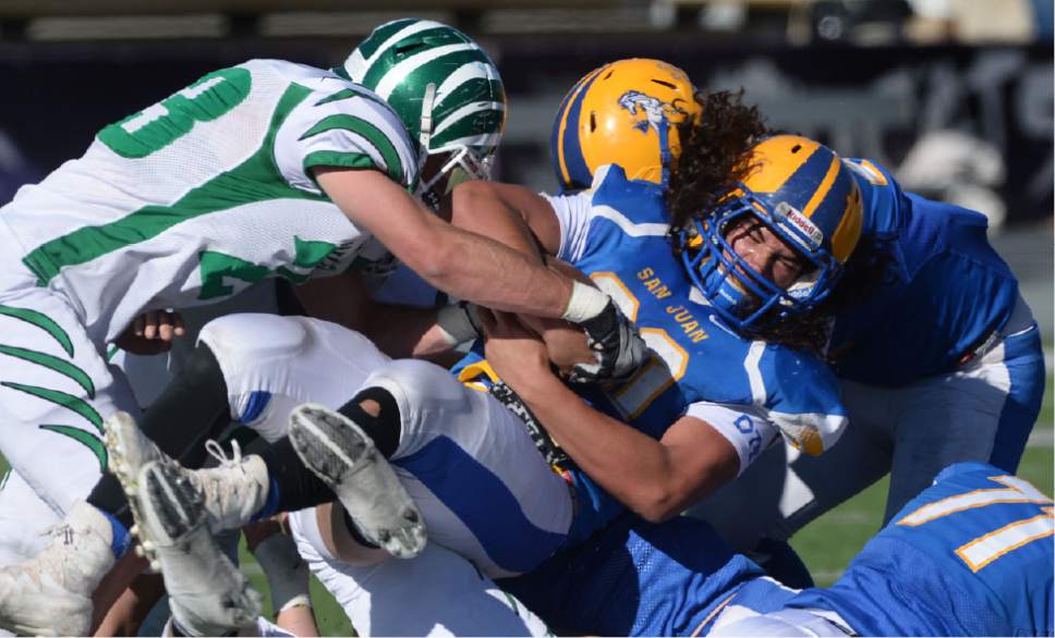 Steve Griffin / The Salt Lake Tribune


San Juan running back Kavika Suesue gets piled up by the South Summit defense during class 2A semifinal football game at Stewart Stadium on the Weber State University campus in Ogden Thursday November 3, 2016.