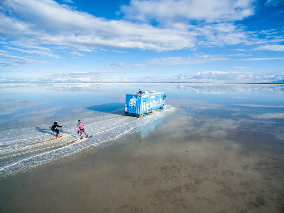 This screenshot of the High On Life Facebook page shows Parker Heuser and Alexey Lyakh waterskiing behind an RV on the Salt Flats west of Salt Lake City.