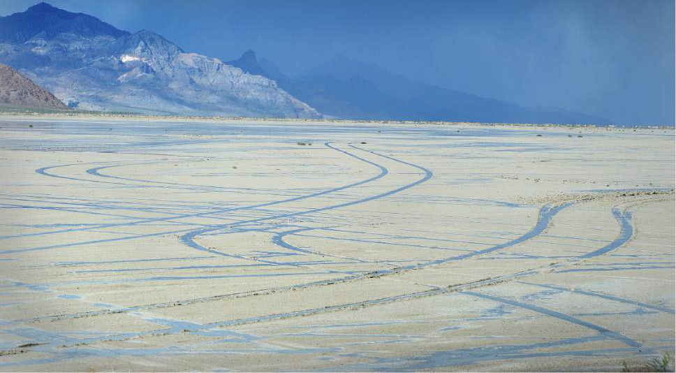 Scott Sommerdorf   |  The Salt Lake Tribune  
Tire tracks left by unknown drivers were not hard to see on the slat flats on Friday, May 27, 2016. despite the numerous signs warning motorists to stay off the salt flats near the Bonneville Speedway..