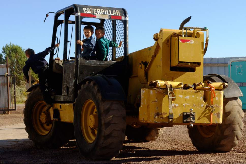 Trent Nelson  |  The Salt Lake Tribune
Pre-pubescent boys dismount from heavy equipment they had been driving and riding on in Hildale, Wednesday September 14, 2016.