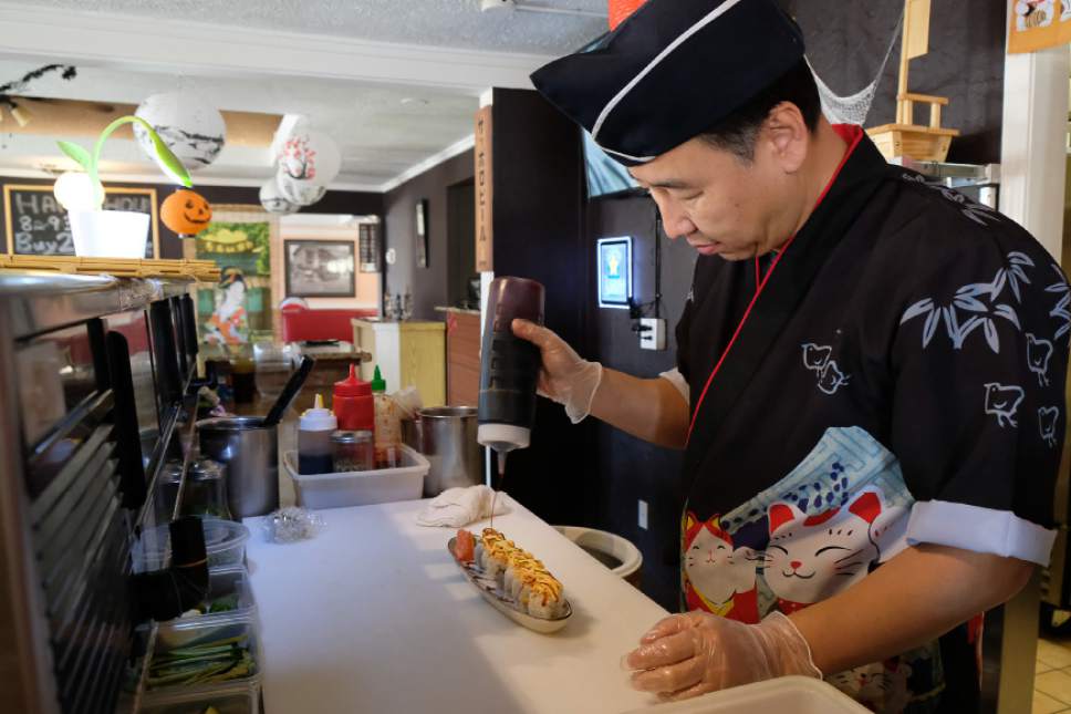 Francisco Kjolseth  |  The Salt Lake Tribune
Jinwoo Shin, chef and owner Hanabi Sushi in Midvale, prepares a Confidential sushi roll during a recent lunch rush.