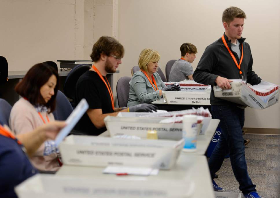 Trent Nelson  |   Tribune file photo
Employees in Salt Lake County's Election Division prepare mail in ballots to be sorted and counted at the Salt Lake County Government Center in Salt Lake City, Tuesday October 18, 2016.