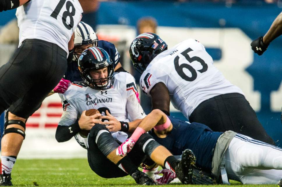 Chris Detrick  |  The Salt Lake Tribune
Cincinnati Bearcats quarterback Hayden Moore (8) is sacked by Brigham Young Cougars linebacker Sae Tautu (31) during the game at LaVell Edwards Stadium Friday October 16, 2015.