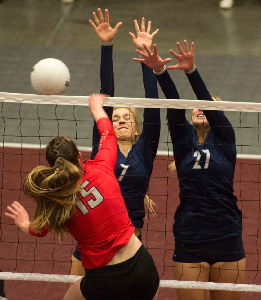 Rick Egan  |  The Salt Lake Tribune

Bountiful Braves Kelsie White (15) hits the ball Corner Canyon Charger defenders, in 4A championship volleyball action, Bountiful vs. Corner Canyon, in Orem, November 5, 2016.