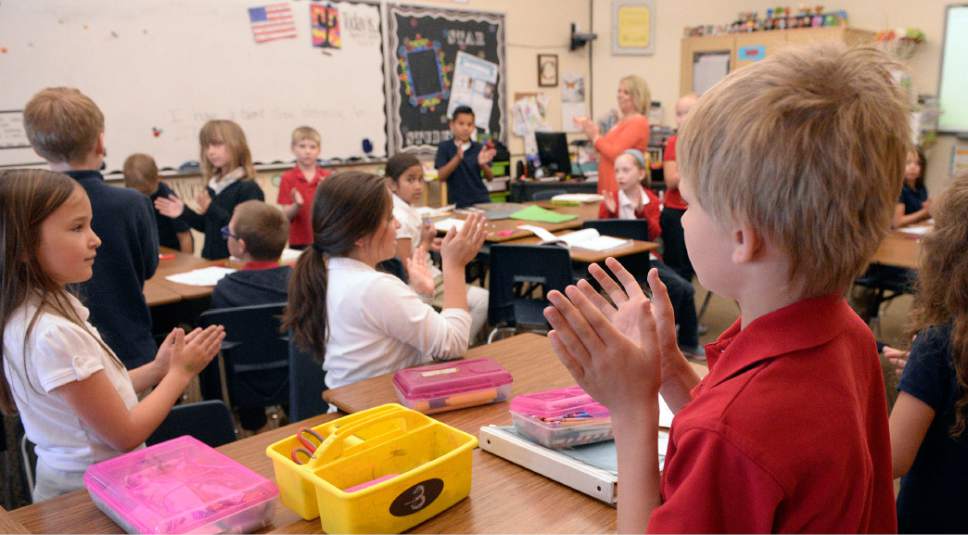 Al Hartmann  |  The Salt Lake Tribune
Second graders at Wasatch Peak Academy, a charter school in North Salt Lake, play a clapping-attention excercise to help them listen and concentrate.