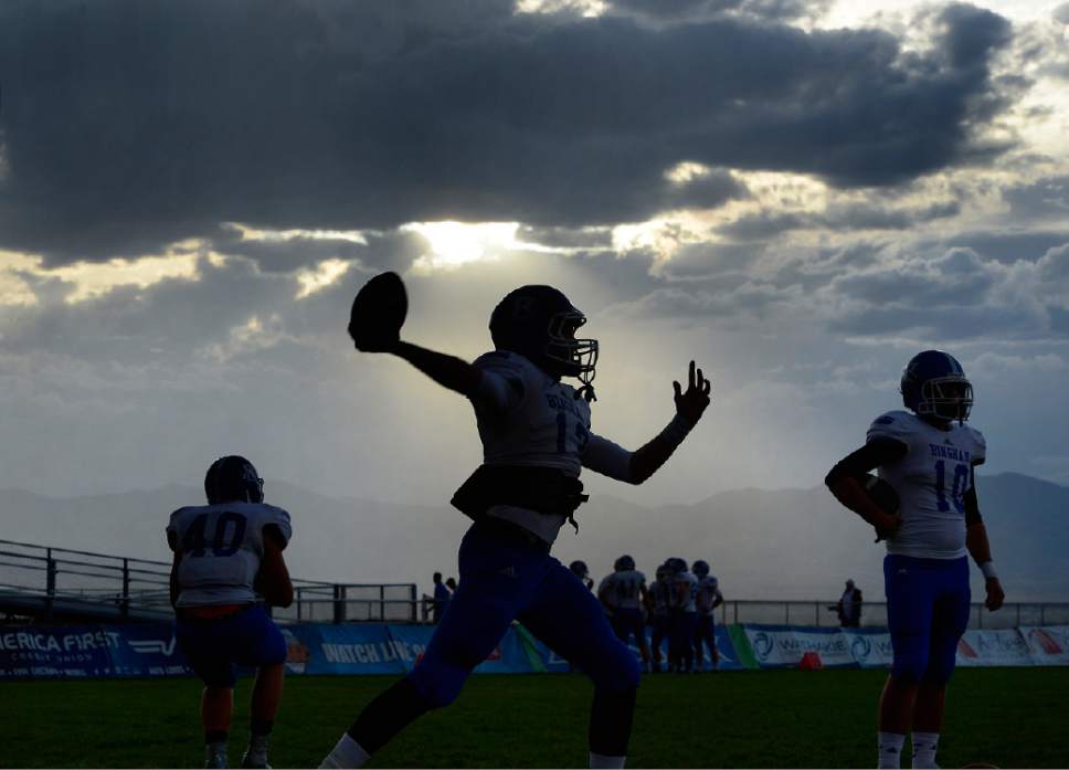 Scott Sommerdorf  |  The Salt Lake Tribune
Bingham player practice under the threatening weather as Brighton hosted rival Bingham in a 5A game played Friday, September 26, 2014. The game was halted for thirty minutes in the first half due to lightning in the area.