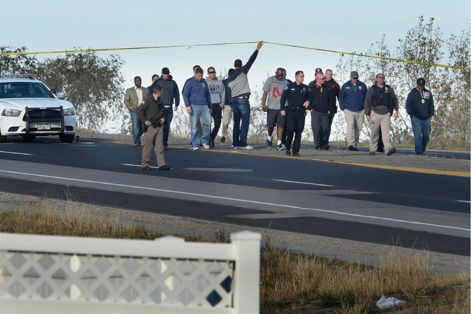 Scott Sommerdorf   |  The Salt Lake Tribune  
Officers and colleagues enter the scene where West Valley City officer Cody Brotherson was struck and killed by a vehicle near 4100s, and 220w in West Valley City, Sunday, November 6, 2016. Later the officers would have an impromptu ceremony as his body was transferred to a hearse.