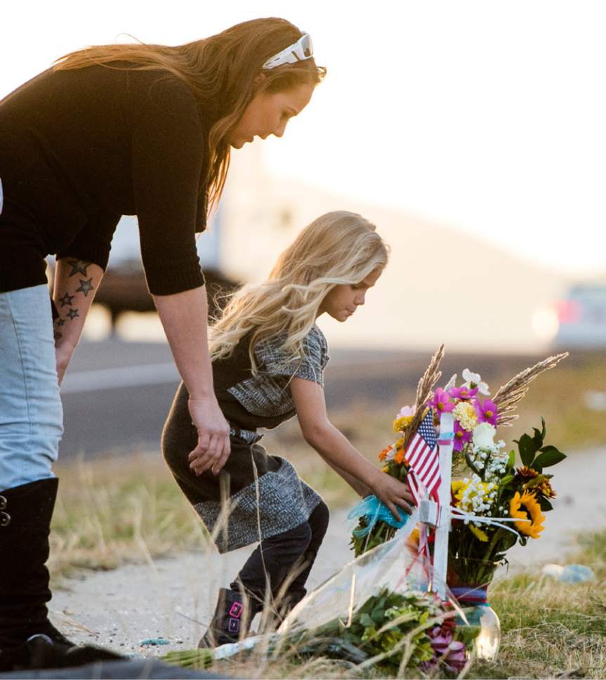 Rick Egan  |  The Salt Lake Tribune

Addy Naisbitt, 5 and her mother Amber Naisbitt, add some flowers to a memorial for West Valley Police officer Cody Brotherson, who was killed in the line of duty early this morning in West Valley City, Sunday, November 6, 2016.