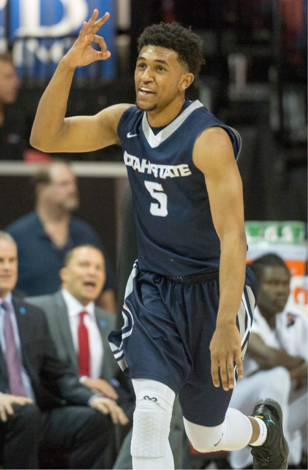 Rick Egan  |  The Salt Lake Tribune

Utah State guard Julion Pearre (5) celebrates after extending the Aggies lead with a three-point-shot in first half action, Utah State Aggies vs. San Diego State Aztecs, in Mountain West Tournament action at the Thomas and Mack Center in Las Vegas, Thursday, March 10, 2016.