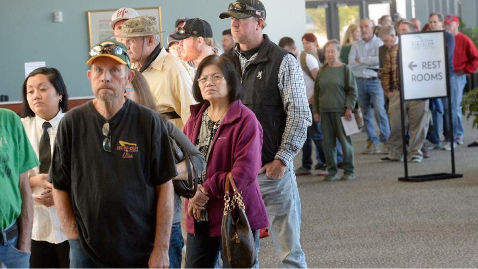 Al Hartmann  |  The Salt Lake Tribune
People line up at the polling station at West Jordan Library on election day Tuesday Nov. 8. Polling staff said they were very busy with people qued up at 6:30 a.m. before opening with waits up to two hours mid-morning.  Good thing there is a restroom nearby.