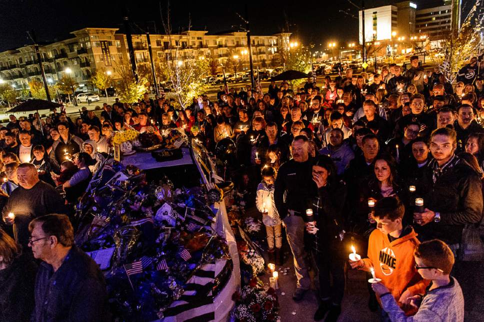 Trent Nelson  |  The Salt Lake Tribune
A crowd gathers around the patrol vehicle of West Valley City police officer Cody Brotherson, who was killed Sunday while apparently trying to lay down tire spikes to stop a fleeing stolen car, during a candlelight vigil in his honor Wednesday November 9, 2016.