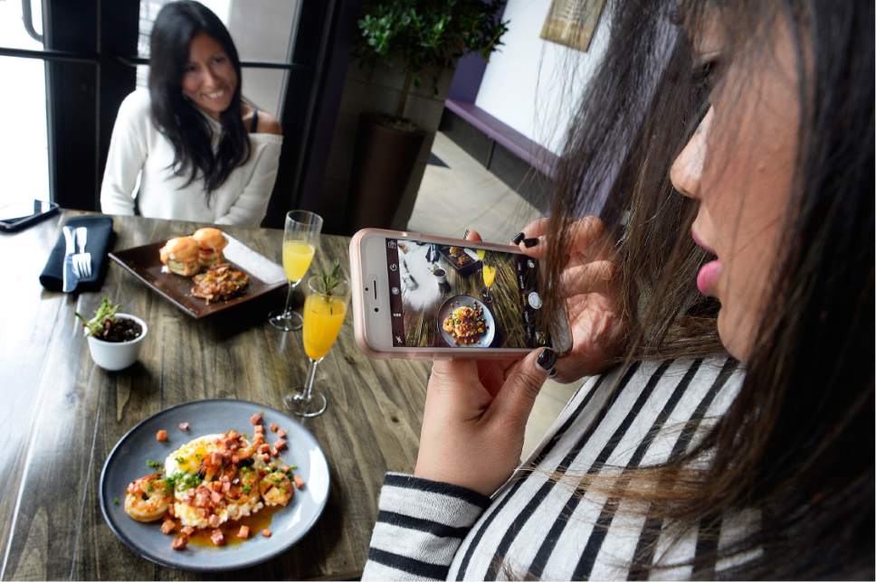 Scott Sommerdorf   |  The Salt Lake Tribune  
Melissa See, right, makes a photo of her brunch at Meditrina as her dining companion Hilda Crispin smiles in the background. Meditrina recently moved to a new location in Salt Lake City's Central 9th business district.