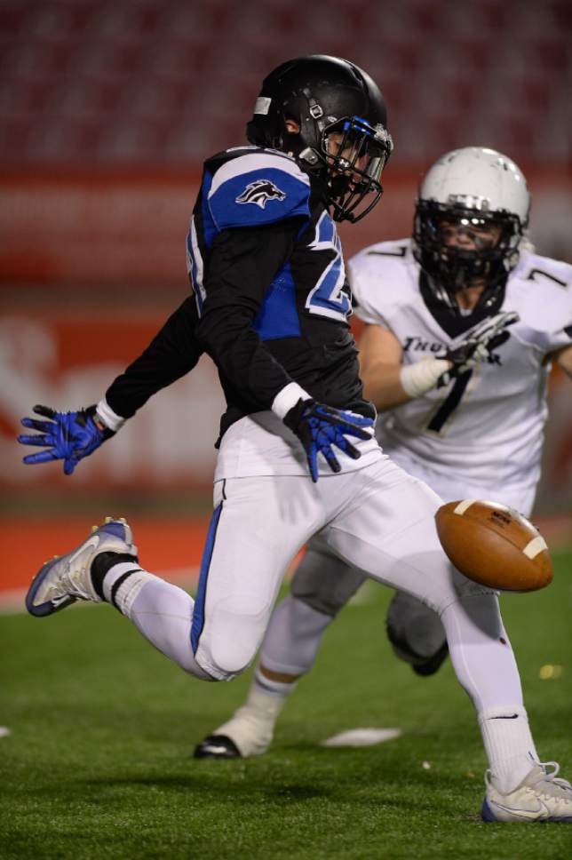 Francisco Kjolseth | The Salt Lake Tribune
Casey Roberts of Stansbury barely manages to get rid of the ball as Jarom Hansen of Desert Hills closes in during the 3AA semifinal football game at Rice-Eccles Stadium on the University of Utah campus in Salt Lake City Thursday, Nov. 10, 2016.