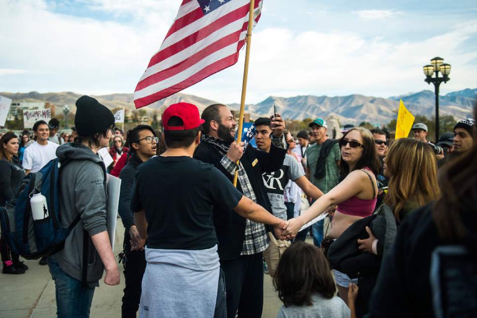 Chris Detrick  |  The Salt Lake Tribune
Pro-Trump supporter Kern Carlos Huerta, center, argues with anti-Trump protestors at the Utah State Capitol during the 'Salt Lake City Protests Trump' event Saturday November 12, 2016.