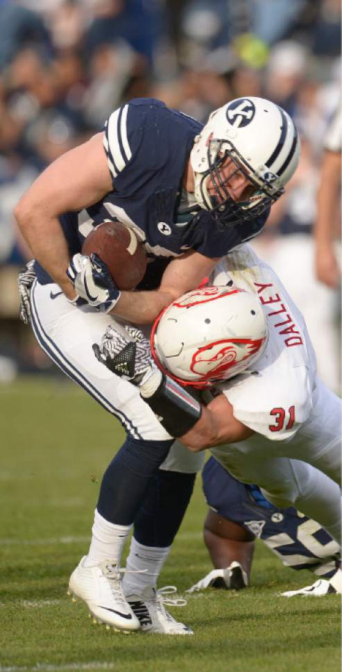 Leah Hogsten  |  The Salt Lake Tribune
Brigham Young Cougars running back Colby Hansen (30) is brought down by Southern Utah Thunderbirds safety Mitch Dalley (31). Brigham Young University defeated Southern Utah University 37-7 during their first match up at LaVell Edwards Stadium,  Saturday, November 12, 2016.