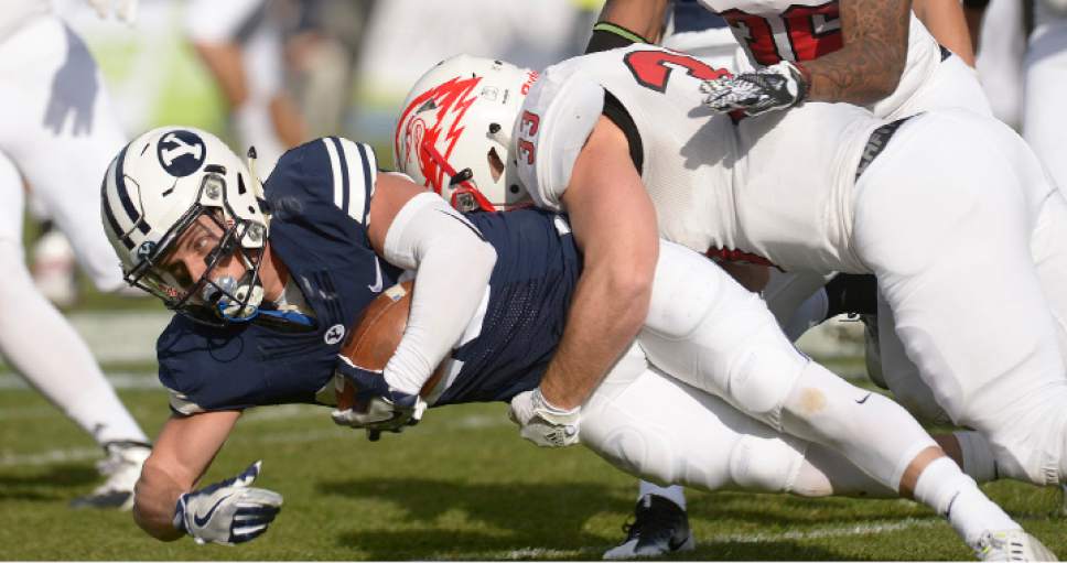 Leah Hogsten  |  The Salt Lake Tribune
Brigham Young Cougars wide receiver Garrett Juergens (23) is brought down by Southern Utah Thunderbirds running back Jarom Healey (33). Brigham Young University leads Southern Utah University 31-7 during their first match up at LaVell Edwards Stadium,  Saturday, November 12, 2016.