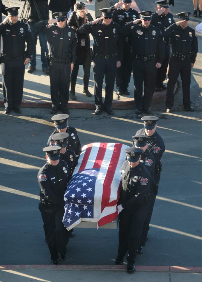 Francisco Kjolseth | The Salt Lake Tribune
Law Enforcement and members of the public salute as Officer Cody Brotherson's flag-draped casket is brought into the Maverik Center on Monday Nov. 14, 2016. Officer Cody Brotherson was killed on Nov. 6 when he was hit and killed by a car he was trying to stop with tire spikes.