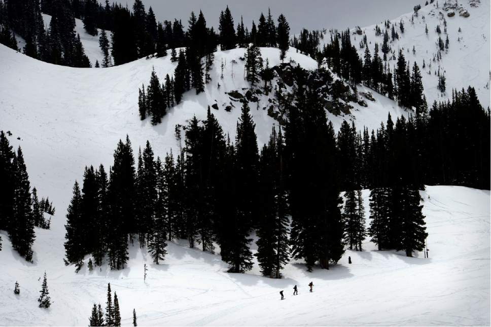 This May 1, 2016, file photo, skiers pay the price for late season turns at Alta, Utah, as they hike up the mountain. Utah resorts still want skiers and snowboarders to come enjoy their groomed slopes and high speed lifts this season, but they're also offering expanded options for people who want to get a taste of the backcountry without the risk of going alone. (Scott Sommerdorf /The Salt Lake Tribune via AP, File)