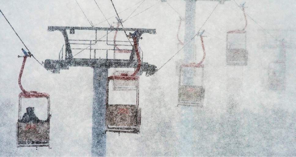 This March 14, 2016, file photo, shows heavy snow blanketing skiers as they ride the gondola from the parking lot to the base of the mountain at Canyons Village ski area in Park City, Utah. Utah resorts still want skiers and snowboarders to come enjoy their groomed slopes and high speed lifts this season, but they're also offering expanded options for people who want to get a taste of the backcountry without the risk of going alone. (Steve Griffin/The Salt Lake Tribune via AP, File)