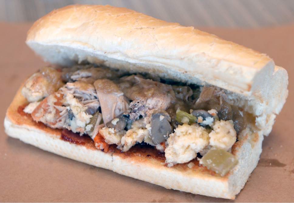 Al Hartmann  |  The Salt Lake Tribune
The "Community Warmer" hoagie at Este Deli. The sandwich is filled with braised turkey, gravy, stuffing using biscuits from  Sweet Lake Biscuits and cranberry orange marmalade from Amour Cafe. $1 from each sandwich will be donated to Utah Community Action to help the homeless.