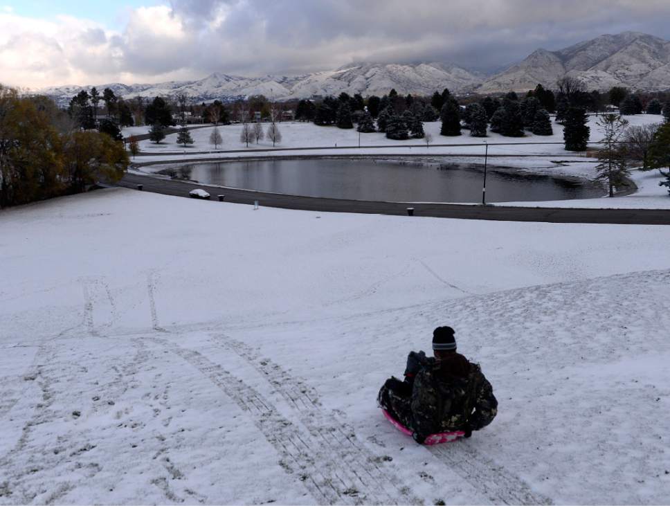 Al Hartmann  |  The Salt Lake Tribune
Sledders take the first run of the season in Sugarhouse Park on Thursday. It was less than an inch but enough to sled.