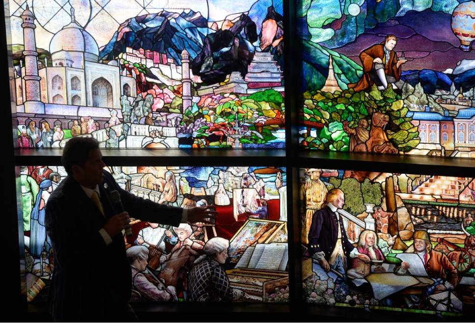 Al Hartmann  |  The Salt Lake Tribune
The Roots of Knowledge, artist Tom Holdman describes one of the many details in a single panel as the entirety was unveiled Friday Nov. 18 at the Fulton Library at Utah Valley University.  This one-of-a-kind 200-foot-long stain-glass mural artwork chronicles humanity's pursuit of knowledge since the dawn of recorded time throughout 80 panes of glass.
