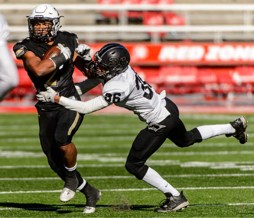 Trent Nelson  |  The Salt Lake Tribune
Desert Hills' Nephi Sewell runs the ball, defended by Jakobe Clausen, as Desert Hills faces Pine View in the Class 3AA high school football state championship at Rice-Eccles Stadium in Salt Lake City, Friday November 18, 2016.