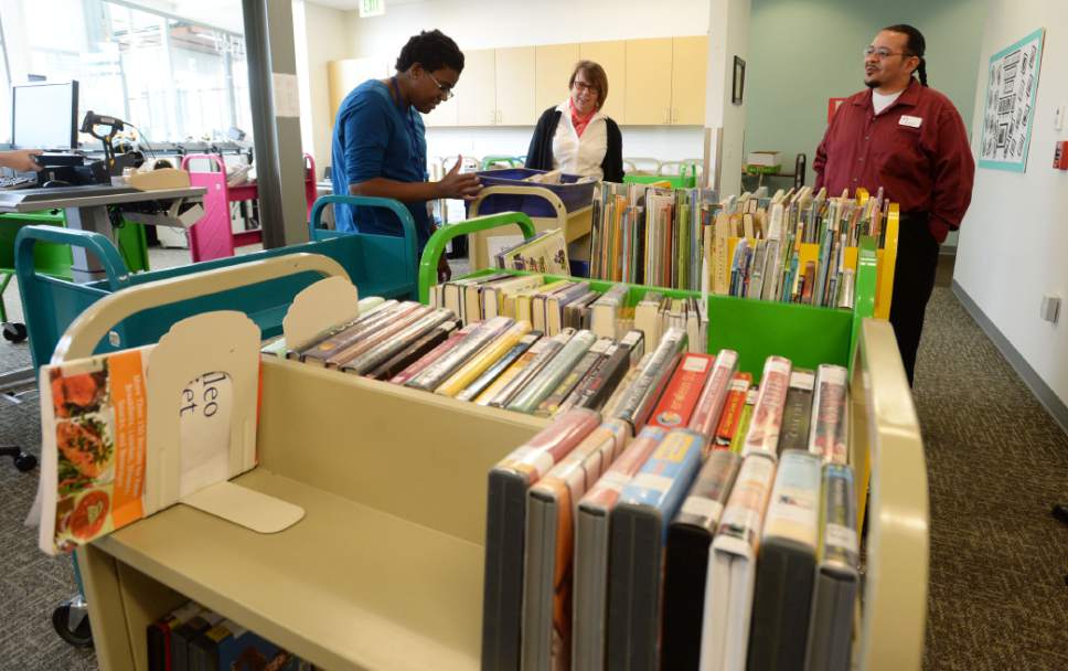 Steve Griffin  |  The Salt Lake Tribune
Library volunteer Meisha Kehl, left, sorts books at the Salt Lake County Library System's Viridian Library in West Jordan. The county system is being honored once again for being a good place to work.