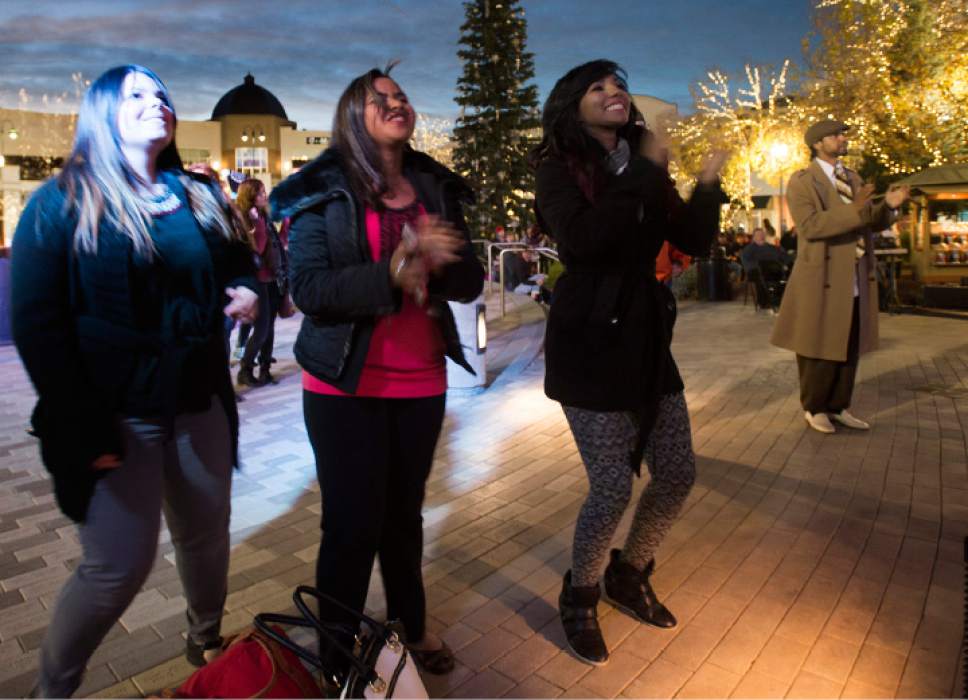 Rick Egan  |  The Salt Lake Tribune

This Ribeiro, Evelyn Alves, and Emily Ray dance to the band "Changing Lanes" at the 16th annual "Light Up The Night" Christmas tree lighting party, Saturday, November 19, 2016.