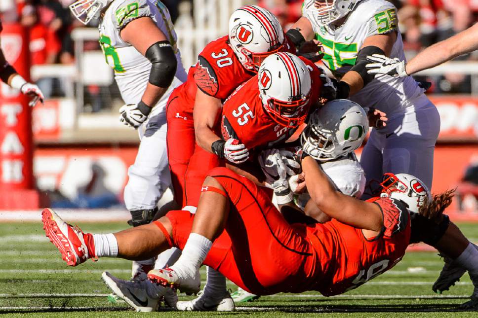 Trent Nelson  |  The Salt Lake Tribune
Utah defenders tackle an Oregon player as Utah hosts Oregon, NCAA football at Rice-Eccles Stadium in Salt Lake City, Saturday November 19, 2016.