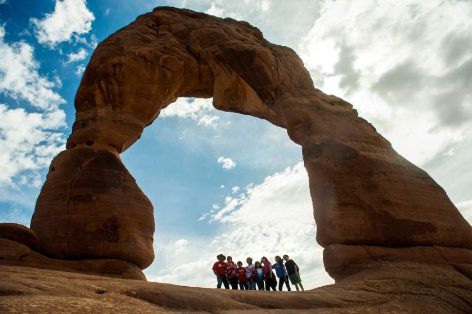 Chris Detrick  |  The Salt Lake Tribune
A family poses for a picture under Delicate Arch in Arches National Park Saturday March 5, 2016.