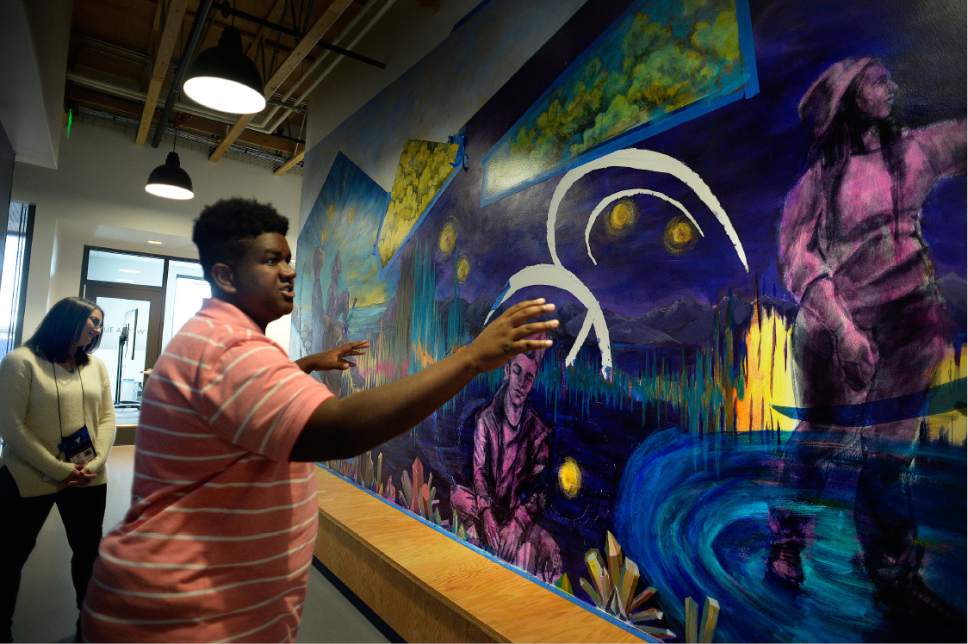 Scott Sommerdorf   |  The Salt Lake Tribune  
Homeless youth Phillip Gant shows the mural that he and other homeless youth helped paint as he led a tour of The Volunteers of America youth shelter, Thursday, November 17, 2016. Gant explained how key the shelter has been for him since he came to Utah from the Forth Worth, Texas area.