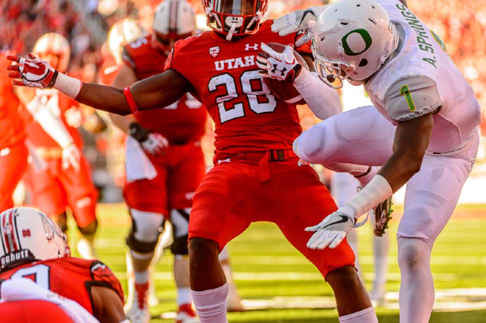 Trent Nelson  |  The Salt Lake Tribune
Utah Utes running back Joe Williams (28) runs for a touchdown, blasting into Oregon Ducks defensive back Arrion Springs (1) as Utah hosts Oregon, NCAA football at Rice-Eccles Stadium in Salt Lake City, Saturday November 19, 2016.