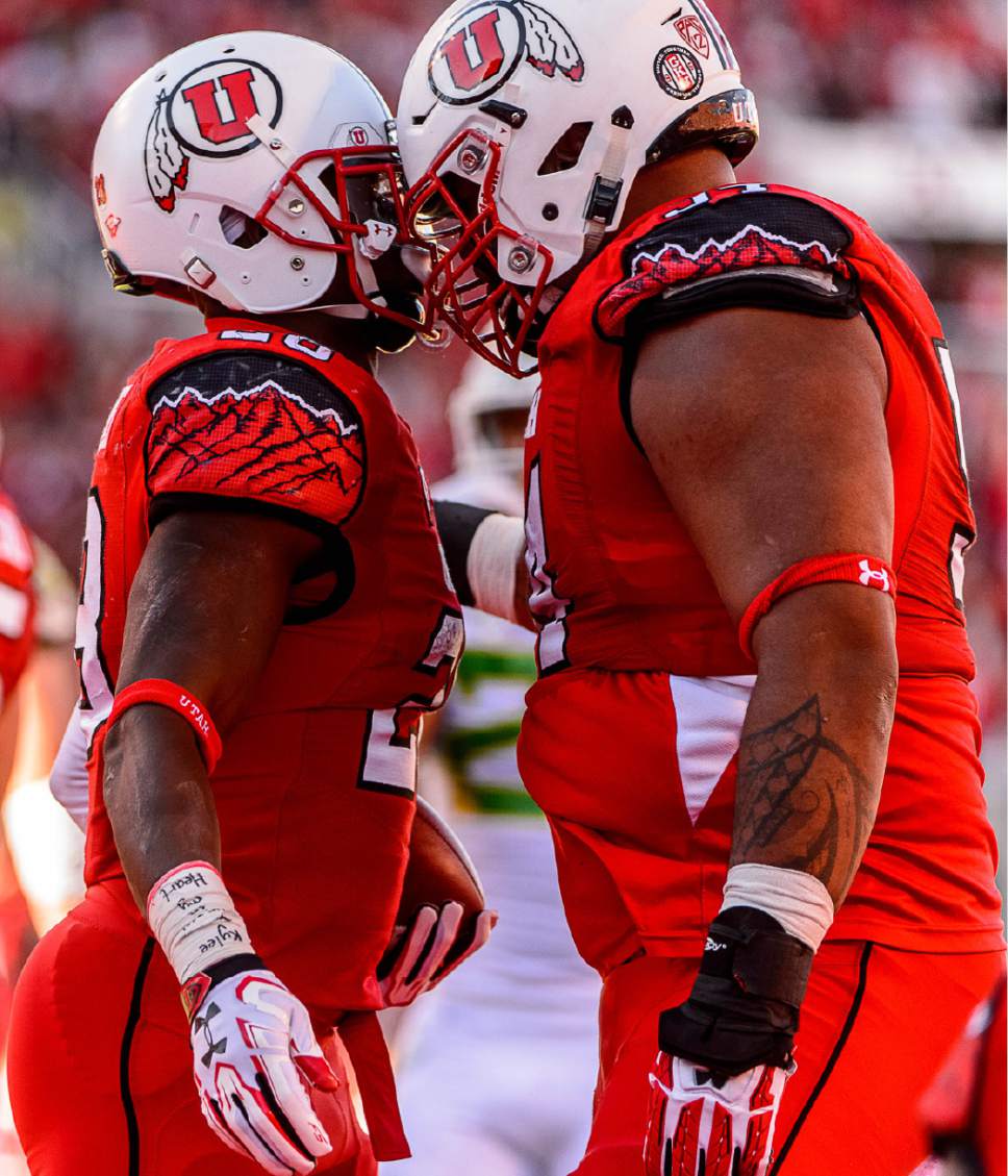 Trent Nelson  |  The Salt Lake Tribune
Utah Utes running back Joe Williams (28) celebrates a touchdown with teammate Utah Utes offensive lineman Isaac Asiata (54) as Utah hosts Oregon, NCAA football at Rice-Eccles Stadium in Salt Lake City, Saturday November 19, 2016.