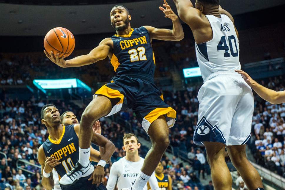 Chris Detrick  |  The Salt Lake Tribune
Coppin State Eagles guard Keith Shivers (22) shoots past Brigham Young Cougars forward Jamal Aytes (40) during the game at the Marriott Center Thursday November 17, 2016.