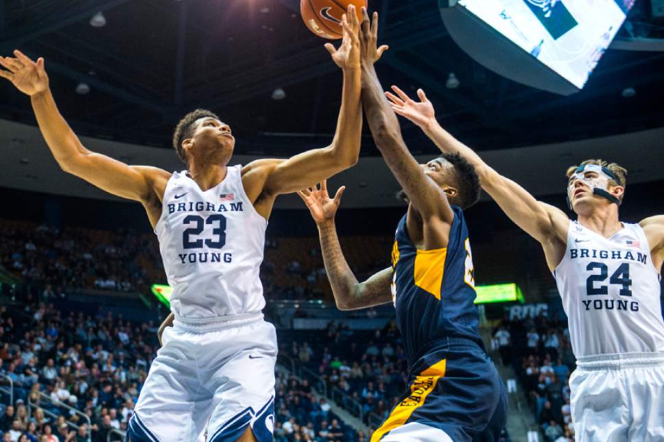 Chris Detrick  |  The Salt Lake Tribune
Brigham Young Cougars forward Yoeli Childs (23) and Brigham Young Cougars forward Davin Guinn (24) guard Coppin State Eagles forward Terry Harris Jr. (25) during the game at the Marriott Center Thursday November 17, 2016.
