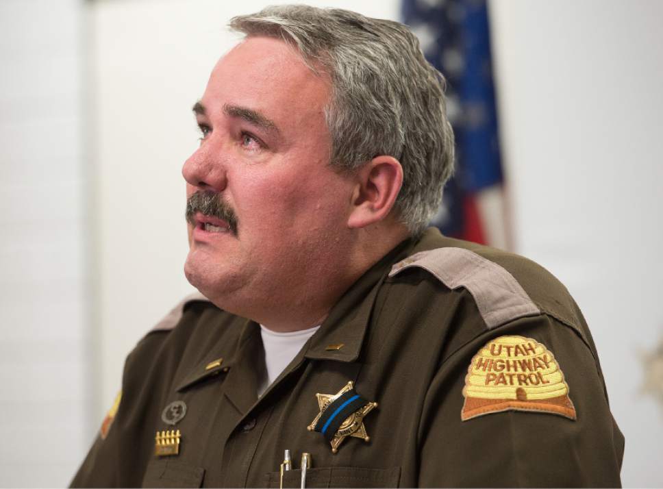 Leah Hogsten  |  The Salt Lake Tribune
l-r Utah Highway Patrol Lt. Lee Perry addresses the media concerning the death of UHP Trooper Eric Ellsworth, age 32, who succumbed to his injuries Tuesday, November 22, 2016, received in the line of duty. Ellsworth was struck by a car on Nov. 18 as he directed traffic at the scene of a downed power line in Box Elder County. Ellsworth had been with the department for seven years and lived in Brigham City with his wife and three young sons. Ellsworth is a second-generation UHP trooper -- his father, Ron Ellsworth, also worked for the department and is now retired.