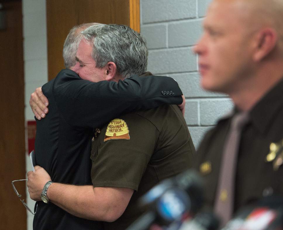 Leah Hogsten  |  The Salt Lake Tribune
Department of Public Safety (DPS) Commissioner Keith D. Squires hugs Utah Highway Patrol Lt. Lee Perry in regards to the Tuesday, November 22, 2016  death of Trooper Eric Ellsworth, who was struck by a car on Nov. 18 as he directed traffic at the scene of a downed power line in Box Elder County. Ellsworth had been with the department for seven years and lived in Brigham City with his wife and three young sons. Ellsworth is a second-generation UHP trooper -- his father, Ron Ellsworth, also worked for the department and is now retired.