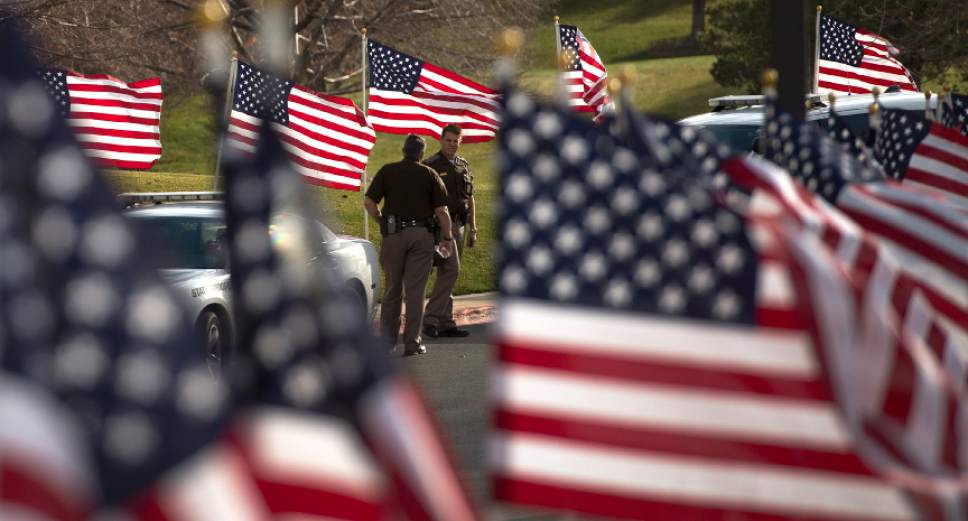 Leah Hogsten  |  The Salt Lake Tribune
In honor of Utah Highway Patrol Trooper Eric Ellsworth,32, who succumbed to his injuries Tuesday, November 22, 2016, received in the line of duty, rows of American flags fill the entrance to the Department of Public Safety Building in Taylorsville. Trooper Ellsworth was struck by a car on Nov. 18 as he directed traffic at the scene of a downed power line in Box Elder County. Ellsworth had been with the department for seven years and lived in Brigham City with his wife and three young sons. Ellsworth is a second-generation UHP trooper -- his father, Ron Ellsworth, also worked for the department and is now retired.