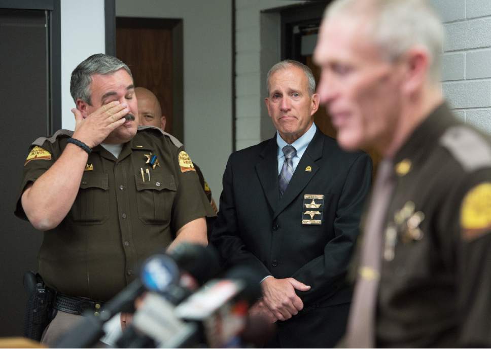 Leah Hogsten  |  The Salt Lake Tribune
l-r Utah Highway Patrol Lt. Lee Perry, Department of Public Safety Commissioner Keith D. Squires wipe their  tears at UHP Colonel Michael Rapich addresses the media concerning the death of UHP Trooper Eric Ellsworth, who at the age of 32, succumbed to his injuries Tuesday, November 22, 2016 that he received in the line of duty. Ellsworth was struck by a car on Nov. 18 as he directed traffic at the scene of a downed power line in Box Elder County. Ellsworth had been with the department for seven years and lived in Brigham City with his wife and three young sons. Ellsworth is a second-generation UHP trooper -- his father, Ron Ellsworth, also worked for the department and is now retired.