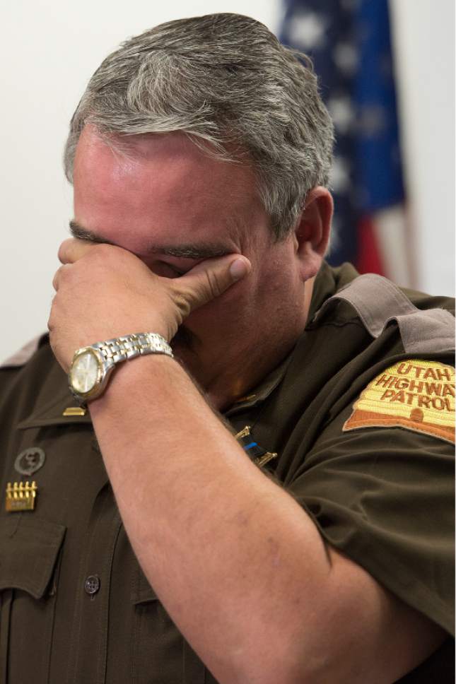 Leah Hogsten  |  The Salt Lake Tribune
l-r Utah Highway Patrol Lt. Lee Perry wipes his tears while he addresses the media concerning the death of UHP Trooper Eric Ellsworth, age 32, who succumbed to his injuries Tuesday, November 22, 2016, received in the line of duty. Ellsworth was struck by a car on Nov. 18 as he directed traffic at the scene of a downed power line in Box Elder County. Ellsworth had been with the department for seven years and lived in Brigham City with his wife and three young sons. Ellsworth is a second-generation UHP trooper -- his father, Ron Ellsworth, also worked for the department and is now retired.