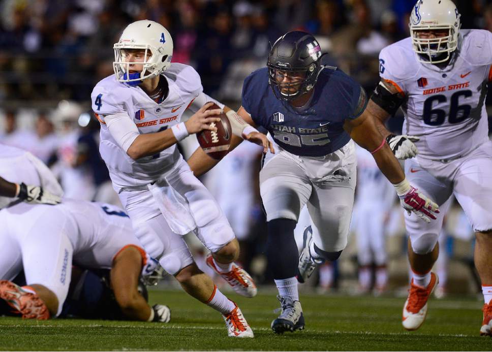 Scott Sommerdorf   |  The Salt Lake Tribune
Boise State Broncos QB Brett Rypien (4) is chased out of the pocket and later sacked by Utah State Aggies DE Ricky Ali'ifua (95) during first quarter play. Rypien fumbled, Utah State recovered and later scored a TD to go up 17-3. Utah State led Boise State 17-3 after one quarter of play, Friday, October 15, 2015.