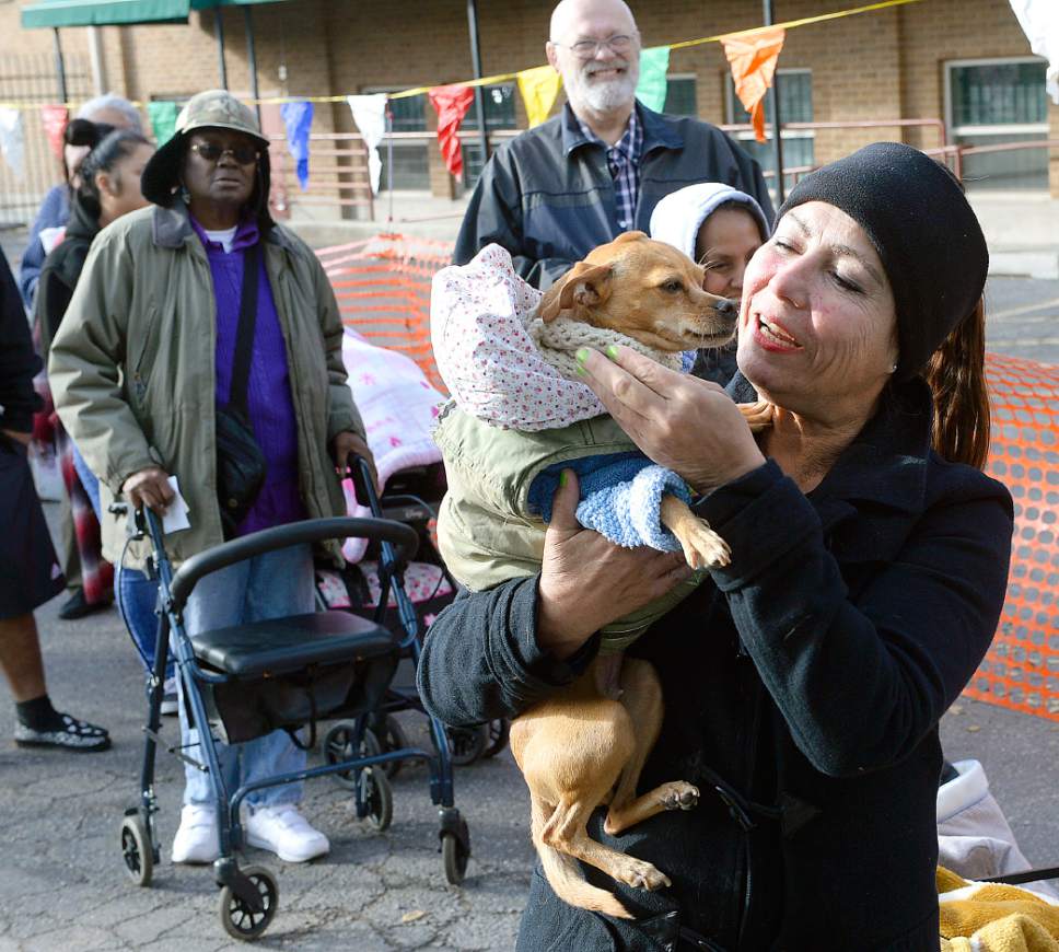 Al Hartmann  |  The Salt Lake Tribune
Elaine Trujillo and her bundled up dog Bambi line up to receive a free turkey and fixings for a complete Thanksgiving Day dinner at the Urban Indian Center in Salt Lake City Wednesday, Nov. 23, 2016.  She was homeless for four years and said it was the hardest work she ever did.  She now lives in senior housing apartment.  She said that she is very grateful for what she has. Crossroads Urban Center, Utah Food Bank and volunteers from civic and business organizations gave away 3,400 turkeys and extras for a Thanksgiving Day meal.  The turkeys and food were donated by Harmon Grocery stores and their customers.