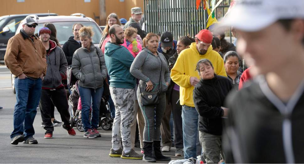 Al Hartmann  |  The Salt Lake Tribune
People line up to get free turkeys and fixings for a complete Thanksgiving Day dinner at the Urban Indian Center in Salt Lake City Wednesday, Nov. 23, 2016.   Crossroads Urban Center, Utah Food Bank and volunteers from civic and business organizations gave away 3,400 turkeys and extras for a Thanksgiving Day meal.  The turkeys and food were donated by Harmon Grocery stores and their customers.
