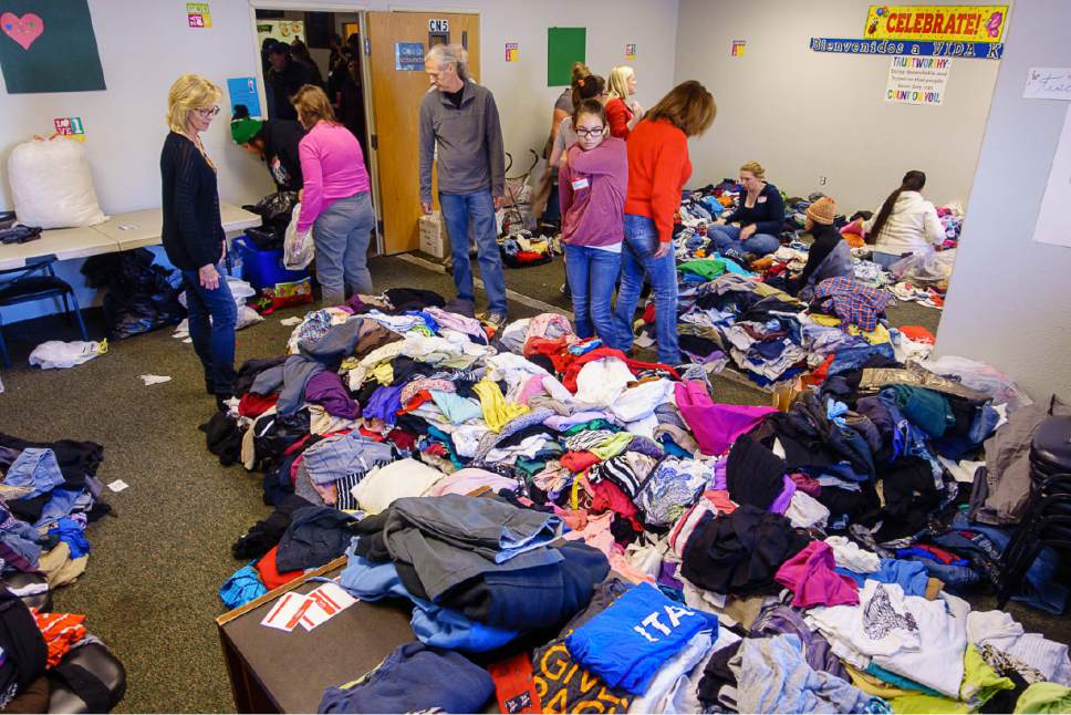 Trent Nelson  |  The Salt Lake Tribune
Volunteers fold donated clothes at the Salt Lake City Mission's Thanksgiving event for the homeless, in Salt Lake City, Thursday November 24, 2016.