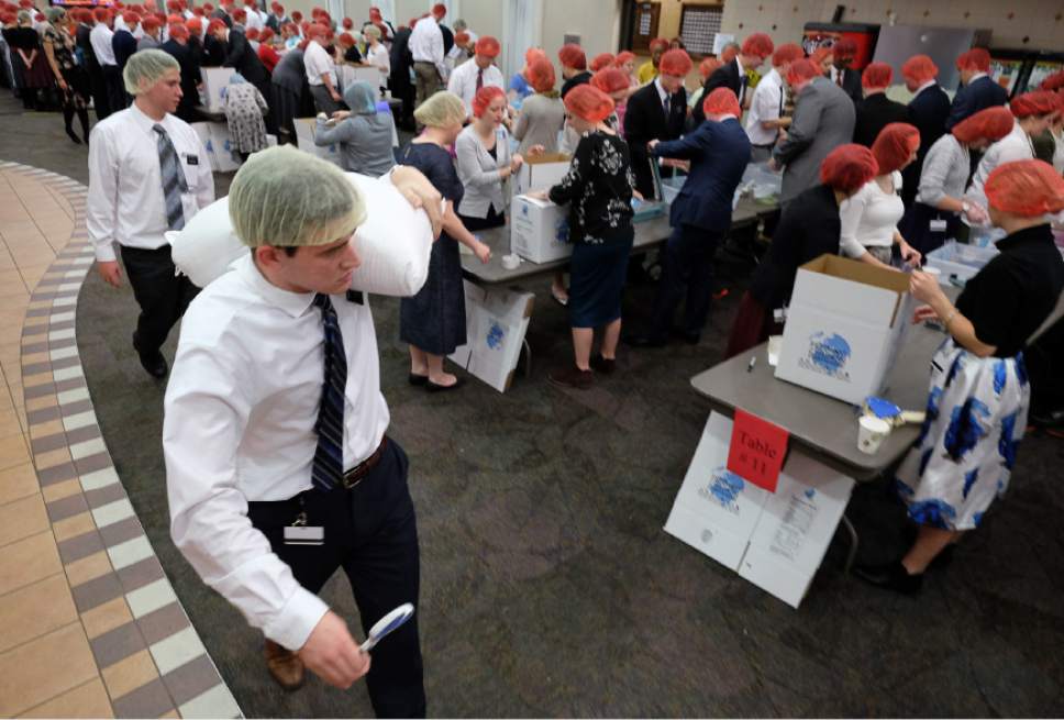 Francisco Kjolseth | The Salt Lake Tribune
Elder Cody Standage of Mesa Arizona joins hundreds of missionaries as he moves sacks of lentils, rice and various grains to be packaged for at-risk children at the Missionary Training Center in Provo on Thursday, Nov. 24, 2016.