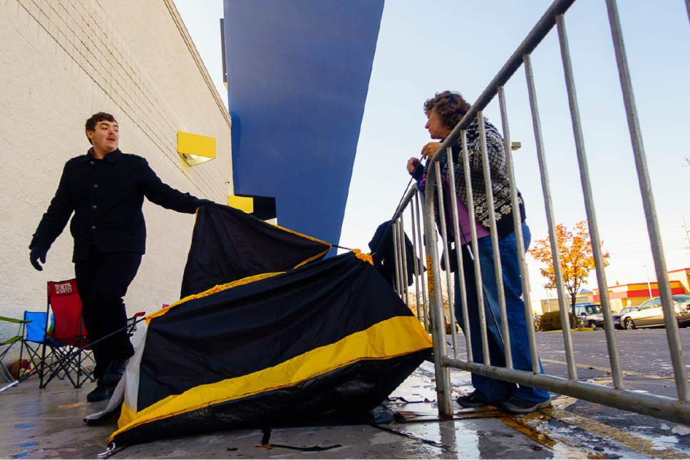 Trent Nelson  |  The Salt Lake Tribune
Cadence Rudd and his mother Andrea Rudd take down their tent, while waiting in line for Black Friday deals in front of the Best Buy in Salt Lake City, Thursday November 24, 2016.